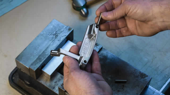 Technician inserting tungsten weight into putter head