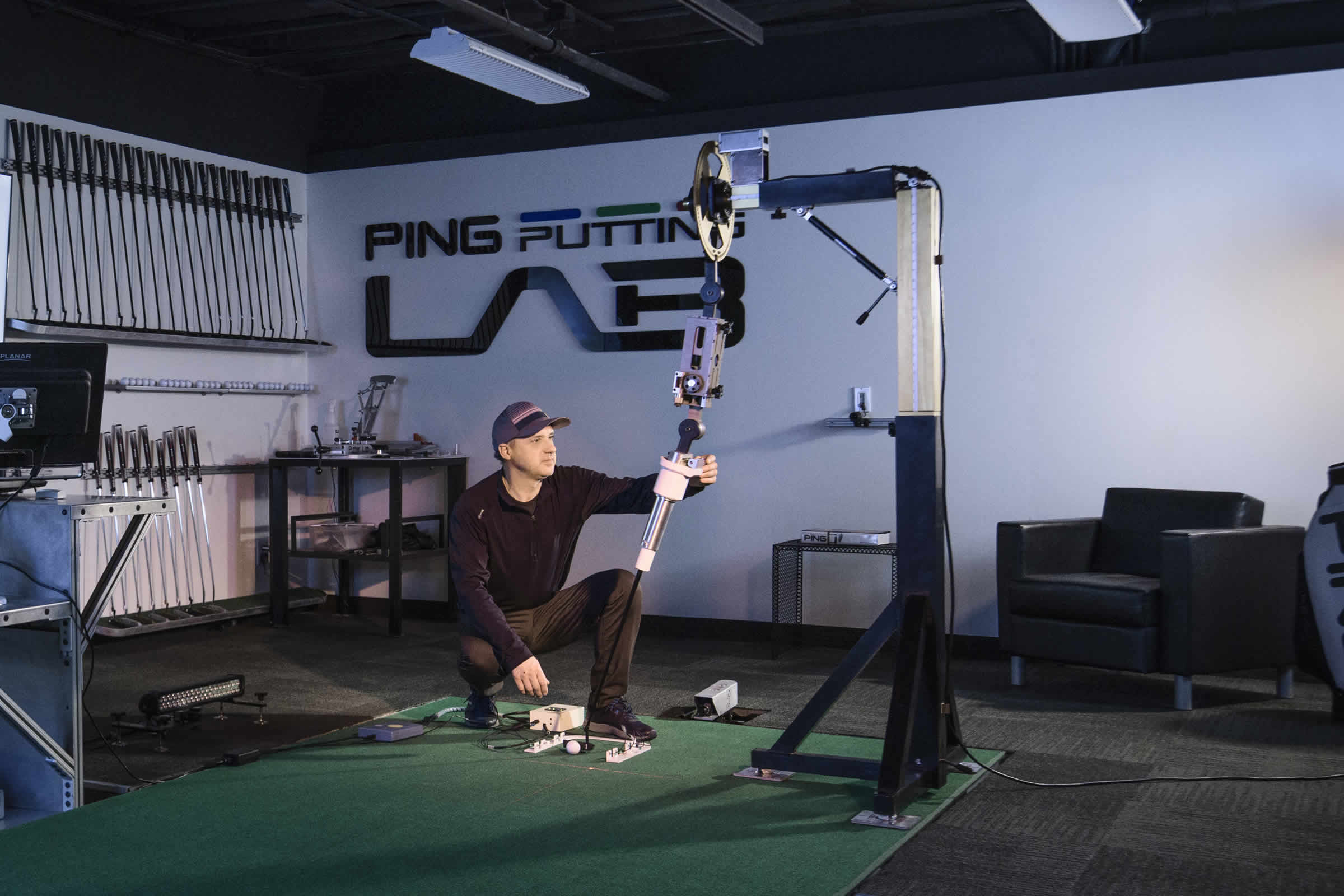 Engineer calibrating the PING putting robot